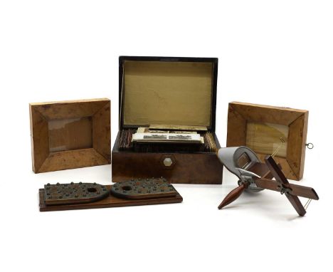 A hand held wooden stereoscopic viewer, manufactured by Underwood &amp; Underwood, New York, 32cm long with a collection of c