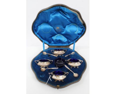 Set of four Edwardian Art Deco-style silver salts of octagonal form, with flared rims and trailing foliate handles, on four p