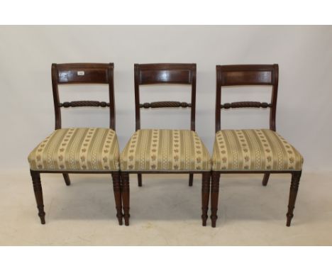 Set of three Regency mahogany ropetwist dining chairs, each with bar top rail and stuffover seat, on ring-turned tapered legs