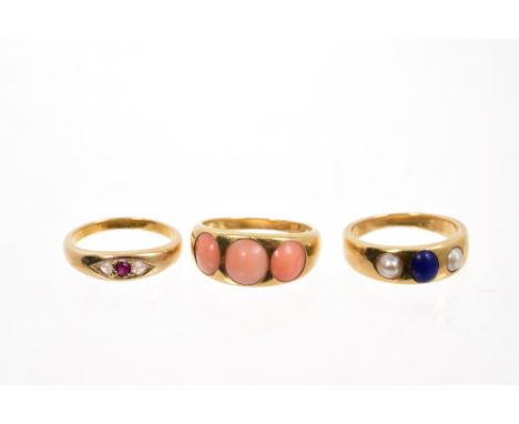 Three Victorian gold rings - to include a pink coral cabochon three stone ring, a Lapis Lazuli and pearl three stone ring and