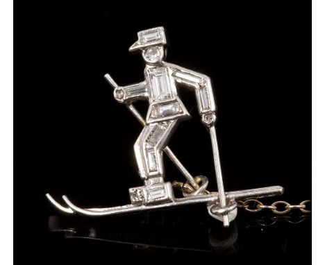 An amusing Art Deco Cartier diamond novelty brooch in the form of a skier, set with circular and baguette cut diamonds in pla