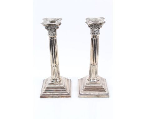 Pair contemporary silver Corinthian column candlesticks with fluted stems and stepped bases, separate sconces (London 1962), 