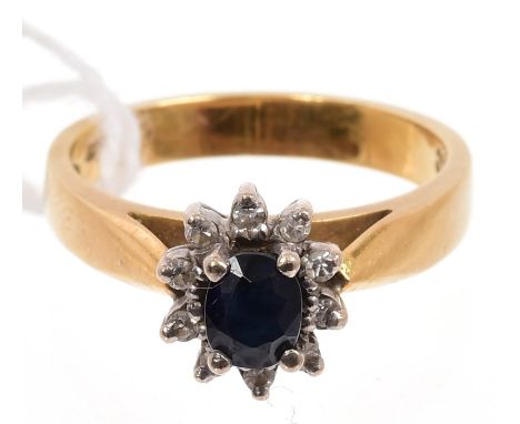 Sapphire and diamond cluster ring with an oval cut blue sapphire surrounded by single cut diamonds.  Ring size L   CONDITION 