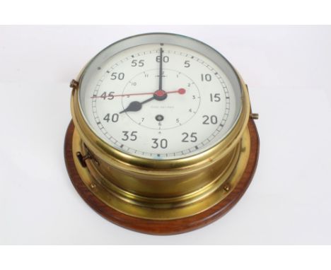 20th century Naval ships' brass bulkhead clock with 23cm diameter brass case, white enamel dial with inner hour dial and out 