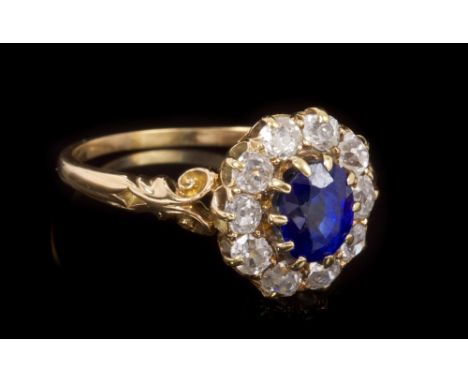 Late Victorian sapphire and diamond cluster ring, the oval mixed cut blue sapphire estimated to weigh approximately 1.65 cara