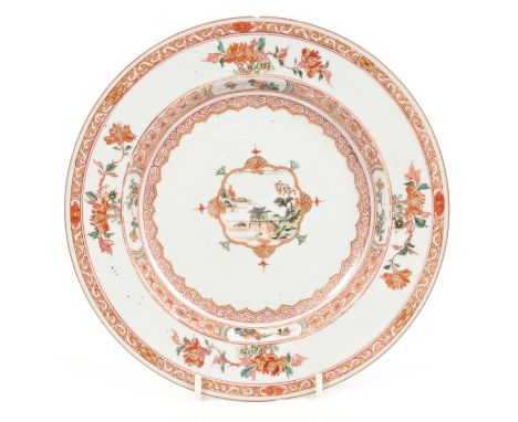 Early 18th century Chinese export porcelain plates, circa 1710, finely painted in rouge de fer palette with landscape and flo