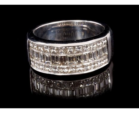 Diamond band ring, the 18ct white gold band set with a central line of baguette cut diamonds flanked by two rows of princess 