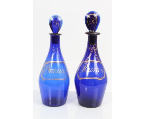 Two late Georgian Bristol blue decanters with pear-shaped stoppers with gilt painted Rum and Brandy labels and 'R' and 'B' to