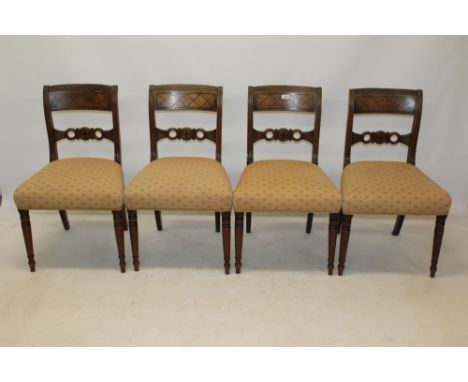 Set of four Regency mahogany and brass inlaid bar back dining chairs, each with stuffover seat, on ring-turned legs