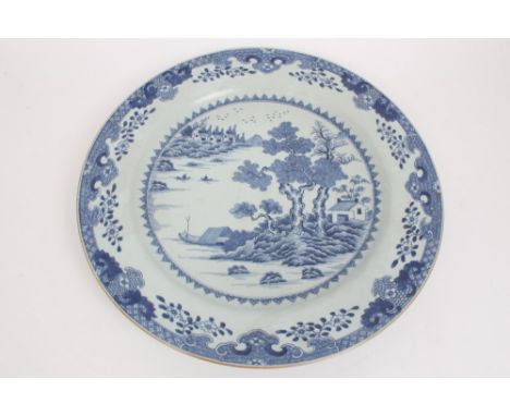 Large 18th century Chinese export blue and white charger with painted Chinese landscape within floral and scale borders, 46.5