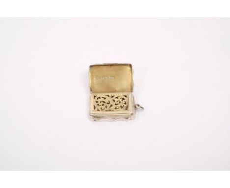 Victorian silver vinaigrette of shaped rectangular form, with suspension ring and engine-turned decoration with scroll border