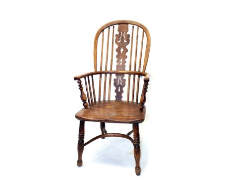 Early 19th century ash and elm windsor elbow chair with arched stick back and pierced splat, with solid saddle seat on turned