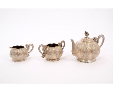 Late 19th / early 20th century Chinese silver three piece tea set - comprising teapot of melon form, with panels decorated wi