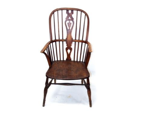 Early 19th century ash and elm windsor elbow chair, the arched stick back centred by pierced vase-shaped splat, with solid sa