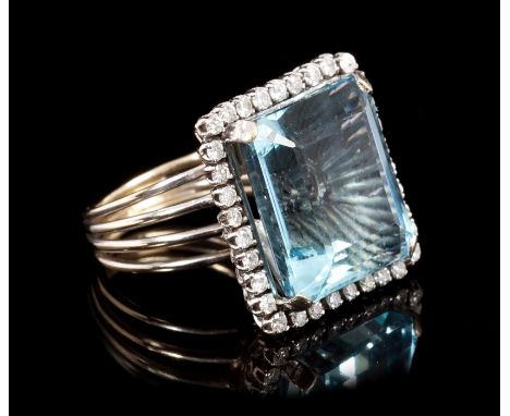 Fine aquamarine and diamond cocktail ring, the rectangular step cut aquamarine estimated to weigh approximately 15 carats, su