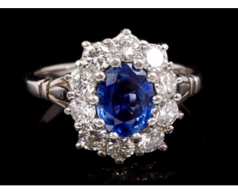 Sapphire and diamond cluster ring, the oval mixed cut blue sapphire estimated to weigh approximately 1.25 carats, surrounded 