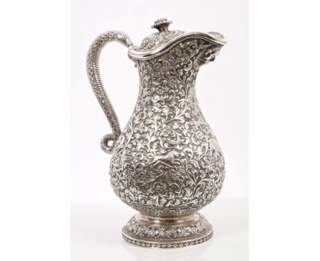 Fine quality 19th century Indian Kutch silver claret jug of baluster form, embossed with floral and foliate decoration, inter