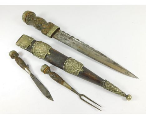 SCOTTISH DIRK. A 19th century Scottish dirk with carved bog oak grip, silver plated thistle design mounts, Cairngorm mounted 