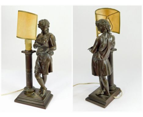 FIGURAL TABLE LAMP. An early 20th c. patinated metal figural table lamp, an artist beside a column. Original cardboard shade.