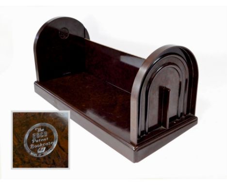 BAKELITE BOOK TROUGH. A brown folding Bakelite book trough, each end stamped The Ebco Patent Bookcase. Length 49cm.  Please n
