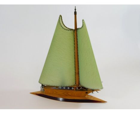 SAILING BOAT TABLE LAMP. A sailing boat table lamp with green celluloid shades & rudder-operated switch. (Some loss of wood t