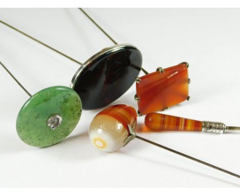 HARDSTONE HAT PINS. A rectangular carnelian hat pit, two banded agate hat pins, a serpentine hat pin & a jadeite hat pin with