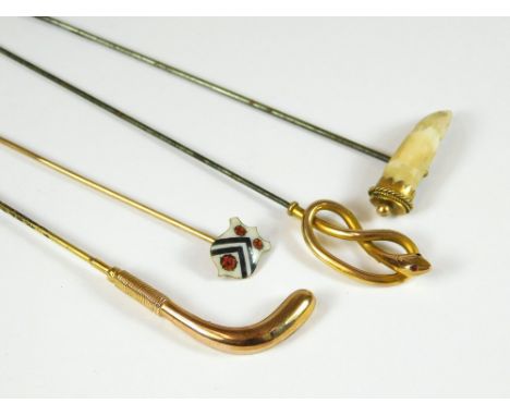 GOLD HAT PINS. Two 9ct. gold hat pins, a hockey stick & a serpent. Also, a Rhodesian gold mounted tusk hat pin & an enamelled