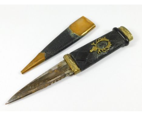 SKEAN DHU. A brass mounted Scottish skean dhu with stag's head motif to grip & Cairngorm pommel. Light rust to blade. Length 