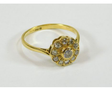 DIAMOND RING. An 18ct. gold diamond set flowerhead ring. Size N/O.  Please note that all items in this auction are previously