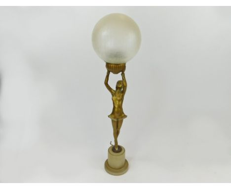 TABLE LAMP. An Art Deco, gilt metal, figural table lamp with crackle glass shade. Height 62cm.  Please note that all items in