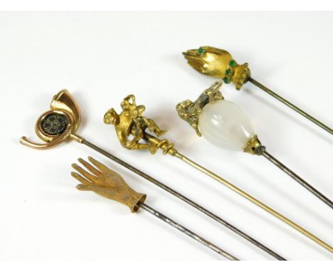 MISCELLANEOUS. Five miscellaneous hat pins, including two gloved hands, a monkey with young, a hunting horn & a lion crest on