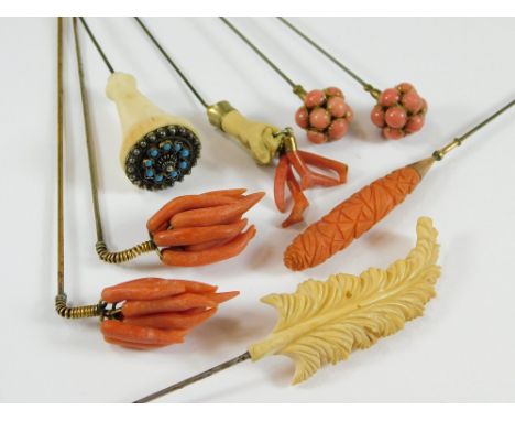 BONE & CORAL HAT PINS. A pair of coral en tremblant hat pins, a carved coral hatpin & a composition hand holding stick coral.