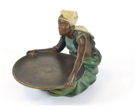 ART DECO FIGURE. An Art Deco, cold painted, low fired figure holding a large dish. Width 18cm, height 19cm.  Please note that