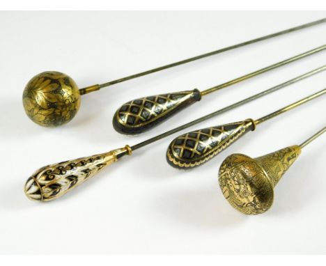 DAMASCENE HAT PINS ETC. Two Japanese damascened hat pins, one with Egyptian motifs. Also, a pair of antique pique work hat pi