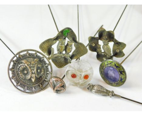 OWL HAT PINS. Various owl hat pins in white metal, pressed metal, silver, enamel & moulded glass. Longest 25.5cm.  All hatpin