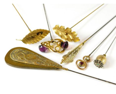 GILT METAL HAT PINS. Seven gilt metal hat pins including a gilt metal heron on wood, an Art Nouveau double thistle hat pin & 