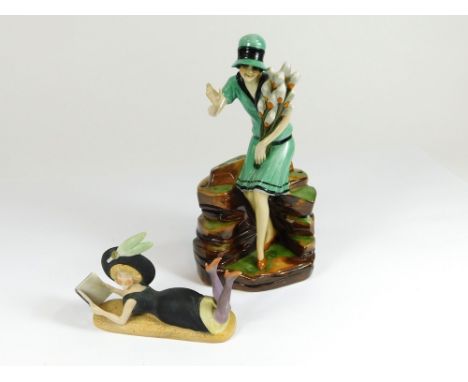 HAT PIN HOLDER. A Continental Art Deco figural hat pin holder, a lady holding tulips. Height 21cm. Also, a Continental bisque