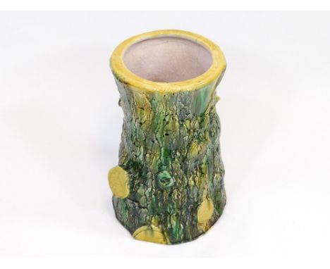 STICK STAND. A 19th century majolica tree trunk stick stand. Unmarked. (Rim crack). Height 48cm.  Please note that all items 