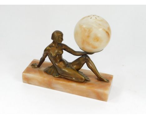 ART DECO TABLE LAMP. An Art Deco, seated figure, table lamp in patinated metal, fitted with a pierced alabaster shade. Length