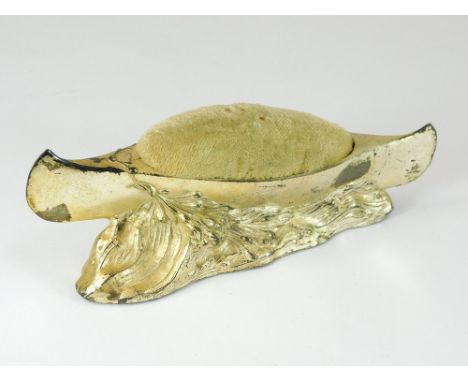 HAT PIN STAND. A canoe hat pin stand in white metal.  Please note that all items in this auction are previously owned & are o
