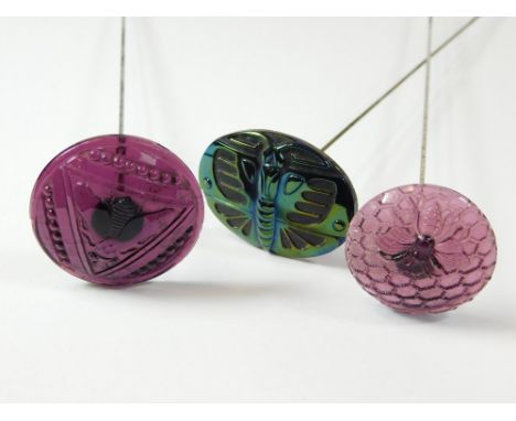 MOULDED GLASS HAT PINS. Two amethyst moulded glass hat pins featuring a fly & a bumble bee. Also, an iridescent glass hat pin