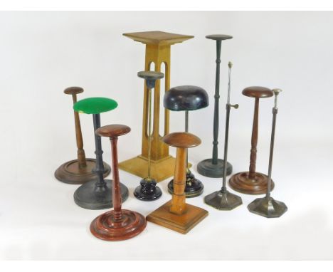 HAT STANDS. Eleven hat or helmet stands in turned wood, painted ceramic or metal. Tallest 46cm.  Please note that all items i