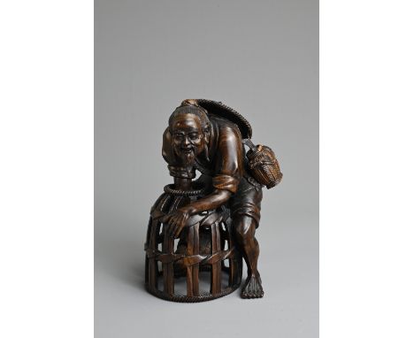 A JAPANESE CARVED WOOD MODEL OF A FISHERMAN, PROBABLY LATE 19TH/20TH CENTURY. Modelled bent over, leaning to reach a fish in 