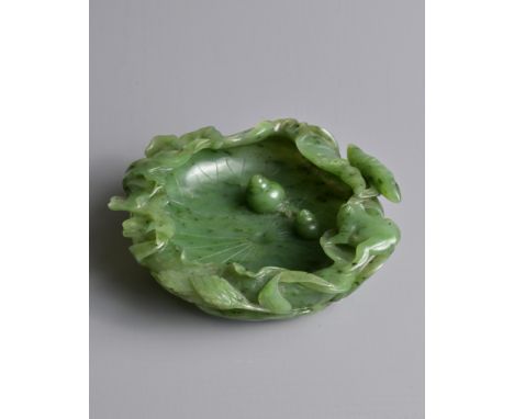 A FINE CHINESE SPINACH GREEN JADE BRUSH WASHER, QING DYNASTY. Finely carved shallow brush washer in the form of an open lotus