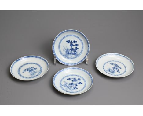 FOUR CHINESE BLUE AND WHITE PORCELAIN SAUCERS, 18TH CENTURY. Each finely potted, decorated with pine trees within hatched bor