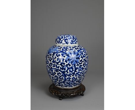 A CHINESE BLUE AND WHITE PORCELAIN JAR AND COVER, LATE 19TH. Decorated with continuous lotus scrolls with a matching cover. F