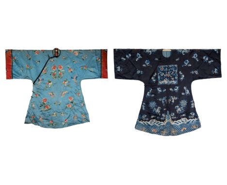 TWO CHINESE EMBROIDERED BLUE-GROUND SILK ROBES, CIRCA 1900 AND LATER. The first, earlier example, of pale blue silk, embroide
