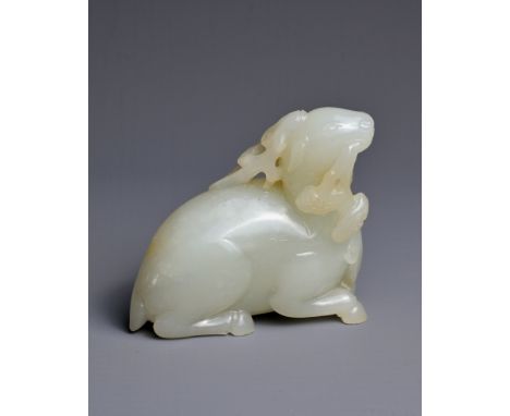 A CHINESE WHITE JADE CARVING OF A DEER, QING DYNASTY. Carved and pierced in the form of a recumbent deer with its head turned