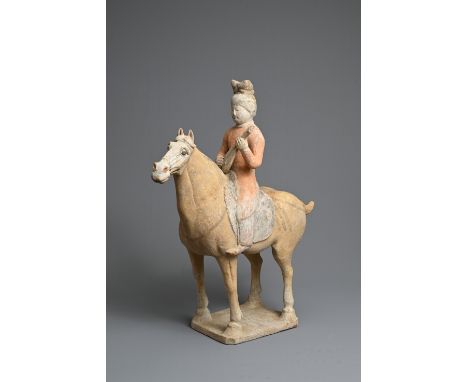 A CHINESE PAINTED POTTERY HORSE WITH MUSICIAN, TANG DYNASTY (618-907). The horse standing four square with a musician playing