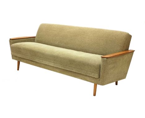 A mid-century daybed,likely German, upholstered in green terrycloth, with teak armrests, raised on tapering teak legs, 200cm 